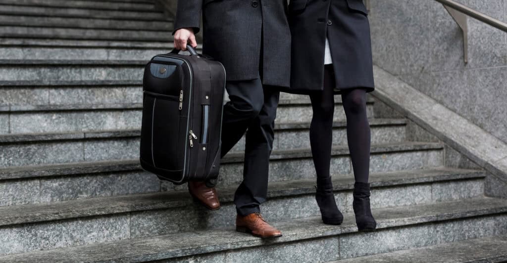 Couple Walking Down Stairs with luggage